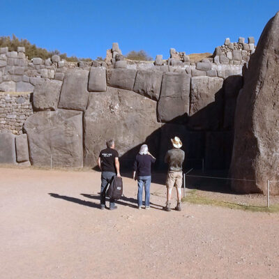 Timothy Alberino observing the megalithic walls of Sacsayhuaman in Cusco, Peru.
