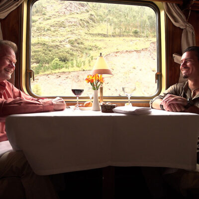 Timothy Alberino and Gary Heavin conversing on the Hiram Bingham train to Machu Picchu, Peru.