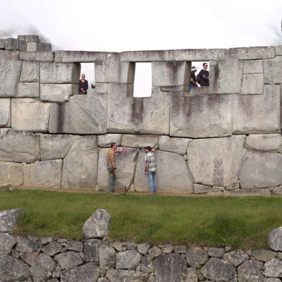 Timothy Alberino examining the megalithic foundations of Machu Picchu, Peru (Temple of the Three Windows).