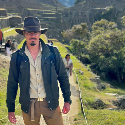 Timothy Alberino exploring the megalithic ruins of Machu Picchu, Peru.