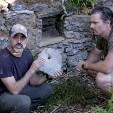 Timothy Alberino examining an artifact form a lost city in the Andes mountain of Peru.