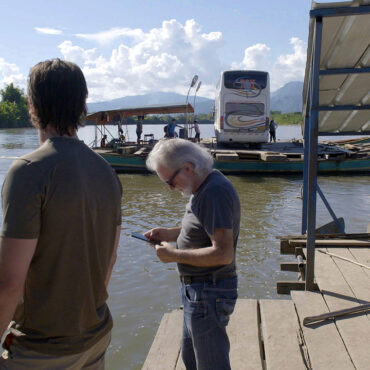 Timothy Alberino and Anselm Pi Rambla crossing the river on expedition to a lost city in the Andes mountains of Peru.