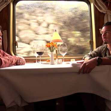 Timothy Alberino and Gary Heavin conversing on the Hiram Bingham train to Machu Picchu, Peru.