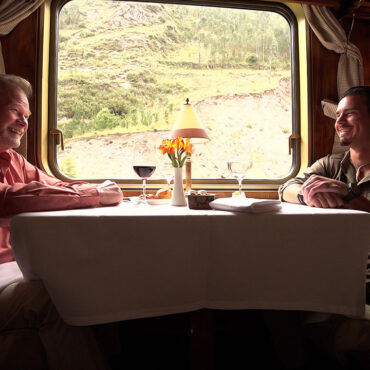 Timothy Alberino and Gary Heavin conversing on the Hiram Bingham train to Machu Picchu, Peru.
