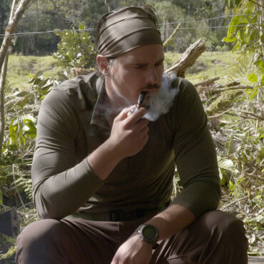 Timothy Alberino smoking a pipe at base camp during an expedition to a lost city in the Andes mountains of Peru.