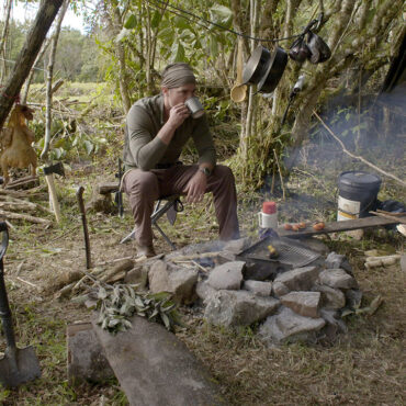 Timothy Alberino drinking coffee at base camp during an expedition to a lost city in the Andes mountains of Peru.